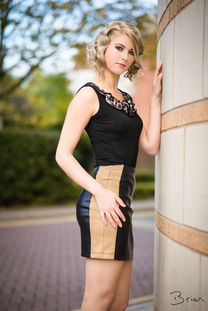 Ruffle tunic in Black tucked into the panelled mini skirt in Black and Camel